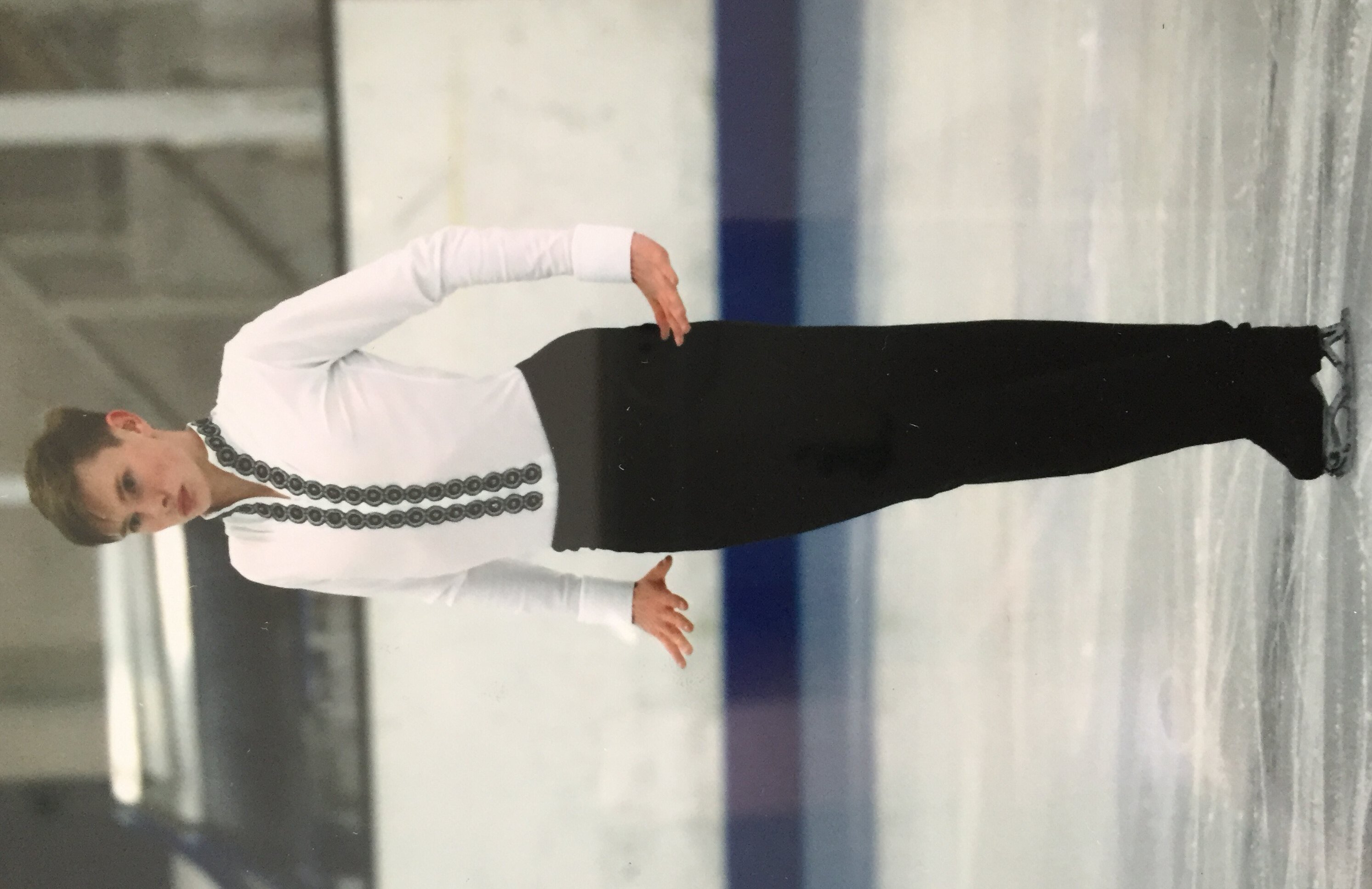 Solo figure skater in white body shirt